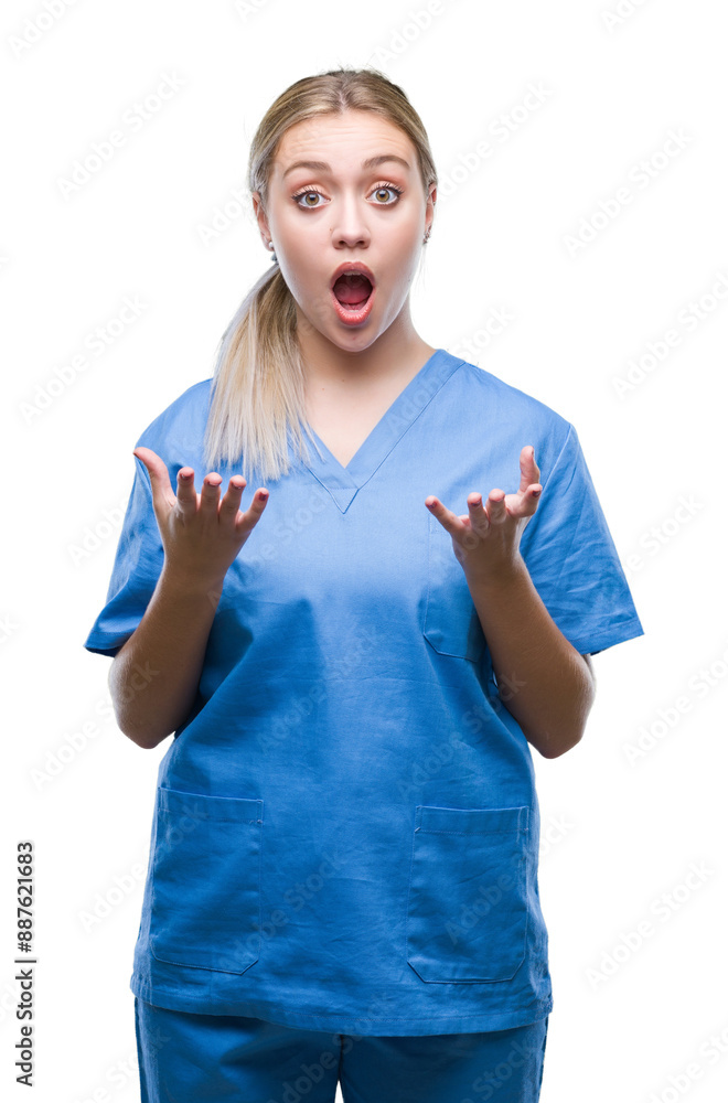 Sticker Young blonde surgeon doctor woman wearing medical uniform over isolated background afraid and shocked with surprise expression, fear and excited face.