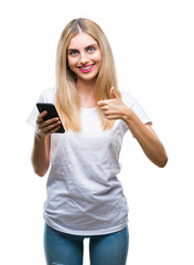 Fototapeta premium Young beautiful blonde woman using smartphone over isolated background happy with big smile doing ok sign, thumb up with fingers, excellent sign