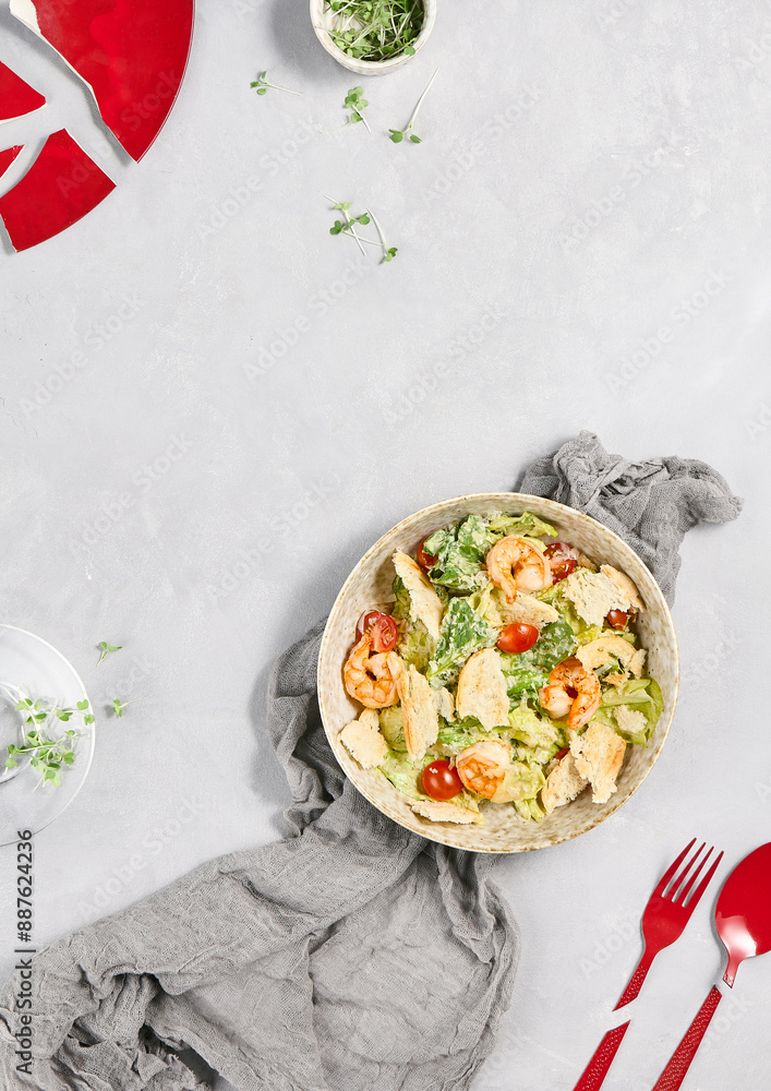 Wall mural fresh caesar salad with shrimp on a light background – flavorful and healthy meal presentation