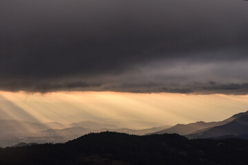 View of sunset light with dark sky over mountains of Oaxaca, México