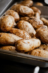 seasoned baked potatoes sitting in a serving pan