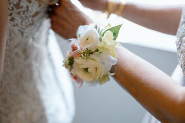 wedding preparation with bride, featuring wrist corsage