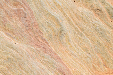 A rock with a brown, red, and yellow color pattern