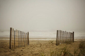 Sand dune weathered fence misty ocean Cape Hatteras