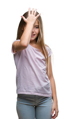 Young beautiful girl over isolated background surprised with hand on head for mistake, remember...