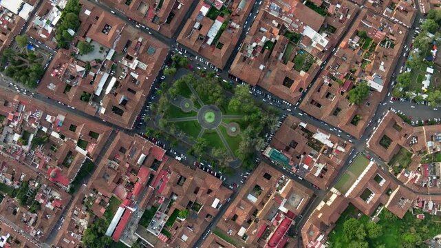 HIGH ALTITUDE TOP DOWN VIEW OF PATZCUARO MICHOACAN MAIN PLAZA AT SUNRISE