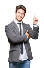 Young business man wearing suit and tie over isolated background with a big smile on face, pointing with hand and finger to the side looking at the camera.