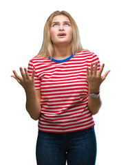 Young caucasian woman over isolated background crazy and mad shouting and yelling with aggressive expression and arms raised. Frustration concept.