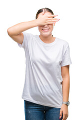 Fototapeta premium Young beautiful caucasian woman over isolated background smiling and laughing with hand on face covering eyes for surprise. Blind concept.