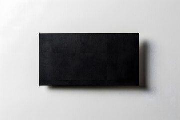 Detailed photograph of single black name card on white background, isolated and clean