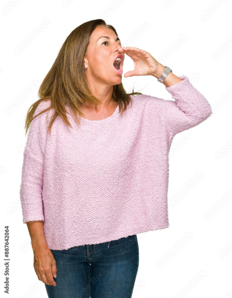 Wall mural beautiful middle age adult woman wearing winter sweater over isolated background shouting and scream