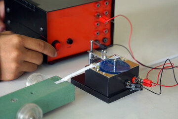 Science classroom, students are conducting a physics experiment on the speed of objects using a...