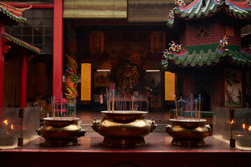 A smoldering incense sticks in traditional Chinese Temple