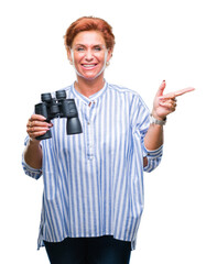 Senior caucasian woman looking through binoculars over isolated background very happy pointing with hand and finger to the side