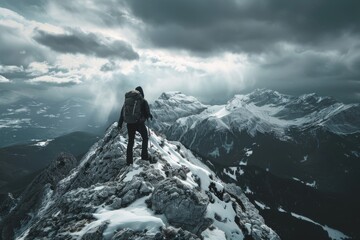Fototapeta premium An image of a man climbing a large mountain at sunset illustrates mountain tourism, travel, and leadership.