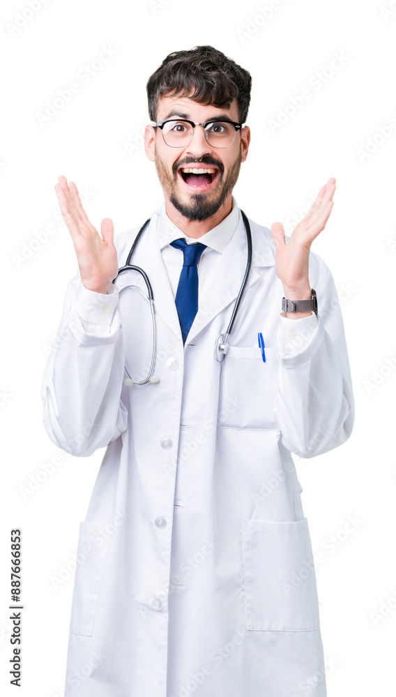 Canvas Prints Young doctor man wearing hospital coat over isolated background celebrating crazy and amazed for success with arms raised and open eyes screaming excited. Winner concept