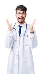 Young doctor man wearing hospital coat over isolated background celebrating crazy and amazed for success with arms raised and open eyes screaming excited. Winner concept