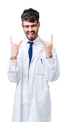 Young professional scientist man wearing white coat over isolated background shouting with crazy expression doing rock symbol with hands up. Music star. Heavy concept.