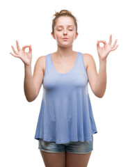 Young blonde woman relax and smiling with eyes closed doing meditation gesture with fingers. Yoga concept.