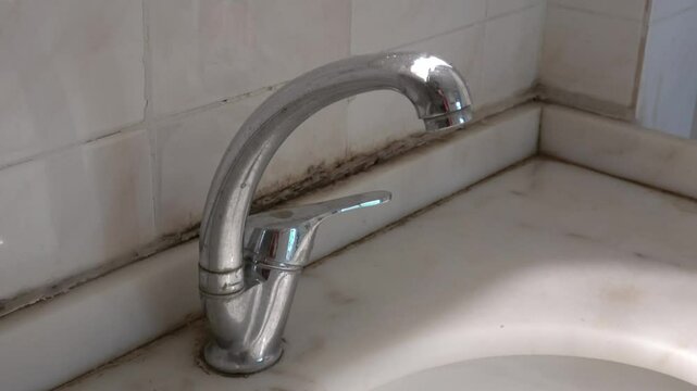 Tuzla, Istanbul, Turkey - 26th of February 2024: 4K Tap and moldy wash-basin cabinet in the bathroom
