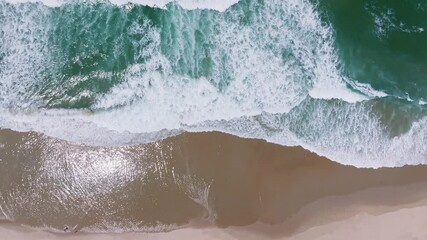 Huge white waves top down view. Peaceful aerial wide beach landscape, summer vacation Mediterranean holiday. Waves crash stunning blue ocean bay sea panoramic coastline. Tranquil aerial drone top view