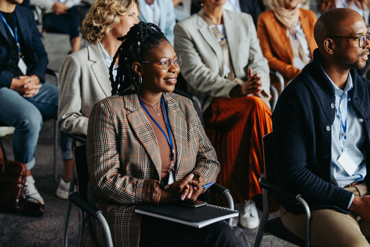 Business conference with diverse audience listening to presentation