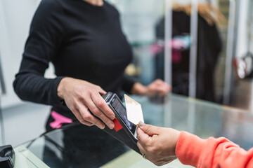 Customer Handing Credit Card to Hair Salon Receptionist for Payment