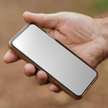 Png screen mockup of smartphone with senior man holding it