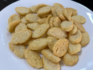 Crispy golden croutons on a white plate, perfect for adding crunch to salads and soups.