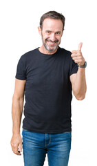 Fototapeta premium Handsome middle age hoary senior man over isolated background doing happy thumbs up gesture with hand. Approving expression looking at the camera with showing success.