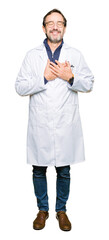Fototapeta premium Middle age therapist wearing white coat smiling with hands on chest with closed eyes and grateful gesture on face. Health concept.