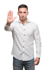 Handsome young business man with open hand doing stop sign with serious and confident expression,...