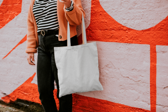 Tote bag png mockup reusable canvas bag carried by a model