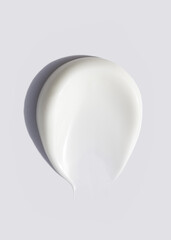 cosmetic smear of creamy texture on gray background