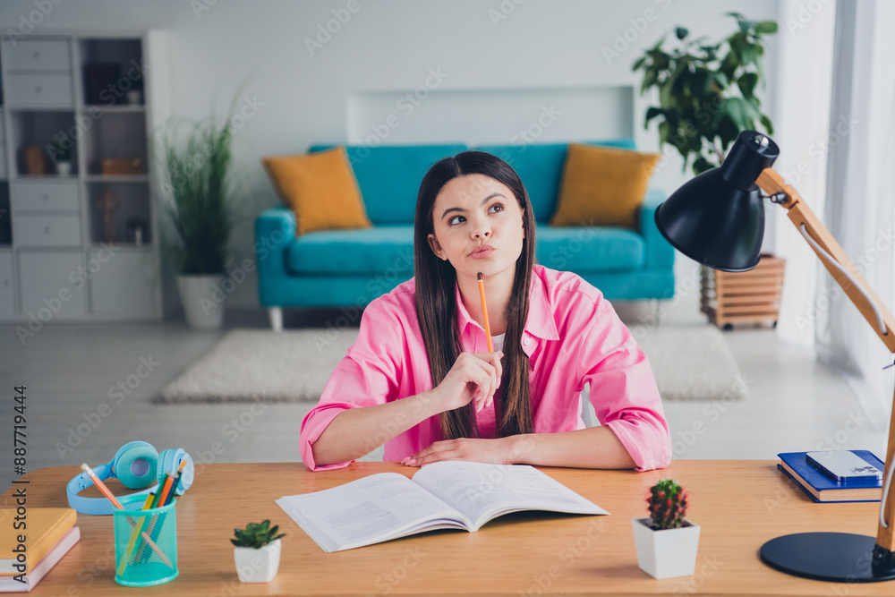 Sticker Photo of doubtful attractive girl dressed pink shirt writing home tasks indoors house apartment room