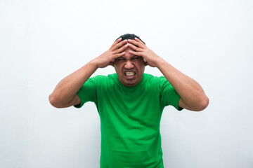 asian man wearing casual shirt standing over isolated white background with hand on head for pain in head because stress. Suffering