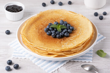 Crepes, thin pancakes with blueberry jam and fresh berries