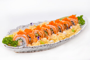 Salmon roll topped with shrimp eggs, set in a porcelain dish, ready to eat.