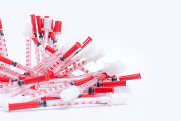 Red plastic syringes isolated on white background with copy space.