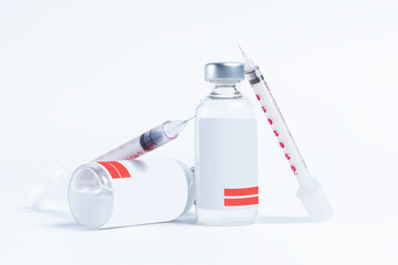 Vaccine bottle and syringe on white background.