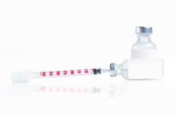 Medical syringe and vaccine vial isolated on a white background