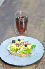 bread with egg ,lettuce and mushroom topping and americano coffee or tea