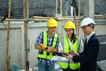 Male project manager and engineers discussing project details at building site