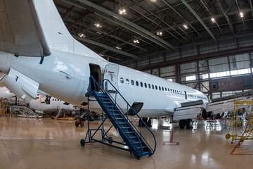 White passenger aircrafts in the aviation hangar