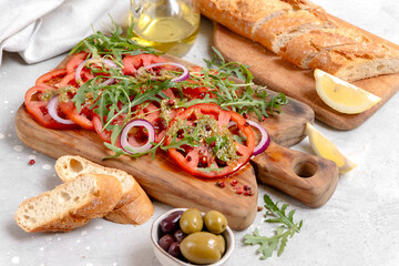 Organic tomato carpaccio with pesto sauce and arugula, an on-trend summer healthy eating salad 