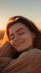 A woman is smiling and resting her head on her arm