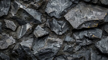 Dark rough and solid rock surface with a natural uneven texture
