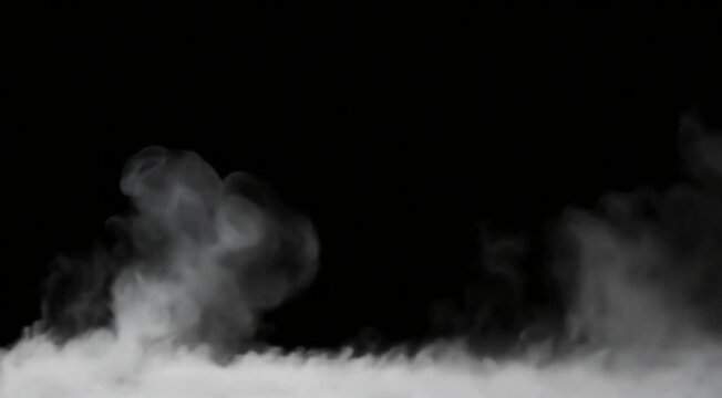 Ground fog swirling smoke rolling low across the ground, isolated on black background