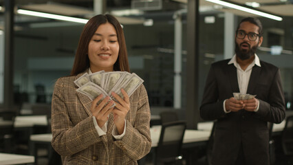 Unequal salary inequality wage discrimination Asian woman rich business girl businesswoman hold big money banknotes female office envy jealousy Indian businessman man male guy shock little finance