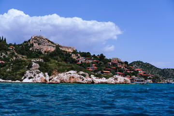 kalekoy Ucagiz village view from the sea while boat tour, castle, red roof houses, historical lycian site